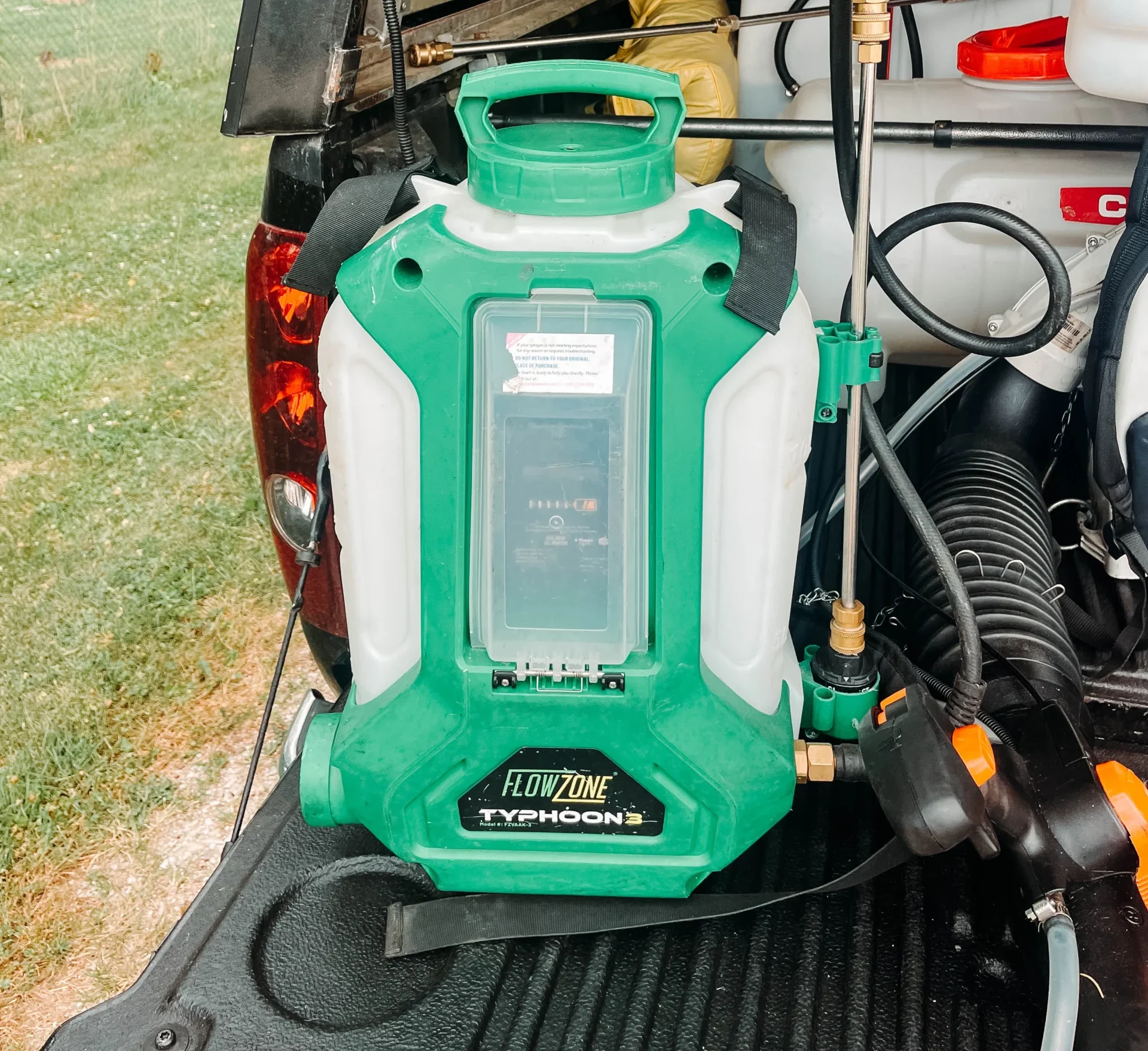 FlowZone Typhoon 3 Sprayer on the back of a truck bed door